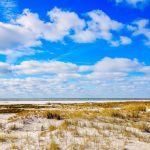 White sand beach on nice day in Dauphin Island, AL