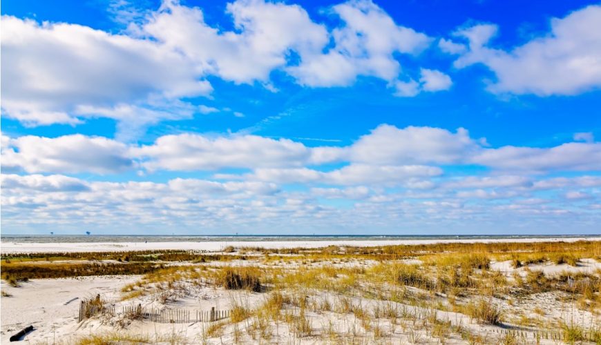 White sand beach on nice day in Dauphin Island, AL