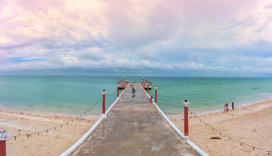 Pier in Sisal, Mexico over emerald waters
